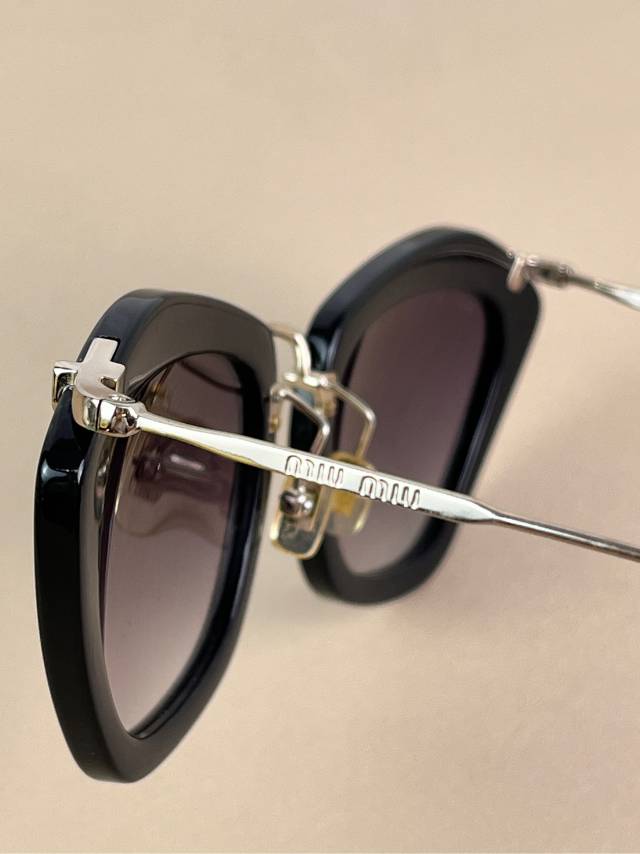 Miu Miu Black Cat-Eye Sunglasses with Gold Arms