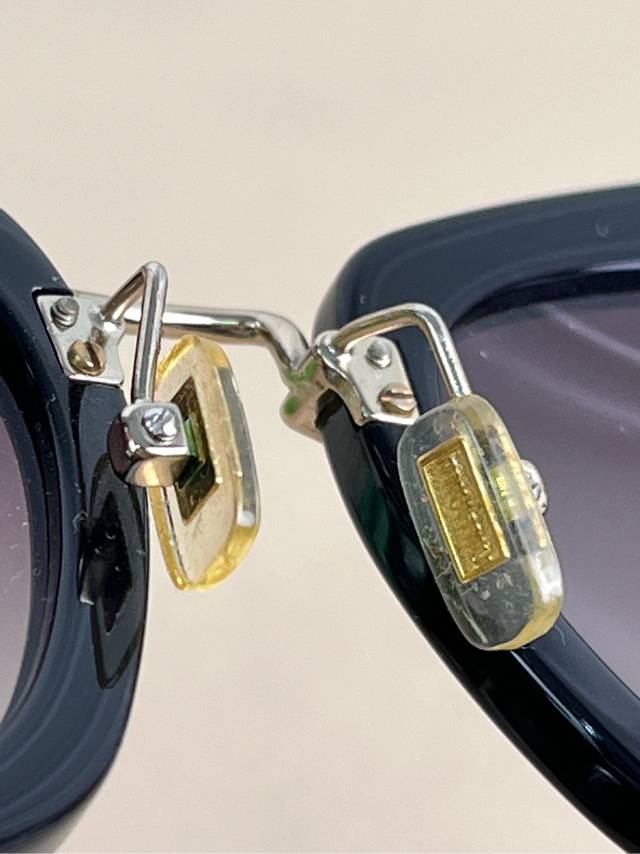 Miu Miu Black Cat-Eye Sunglasses with Gold Arms