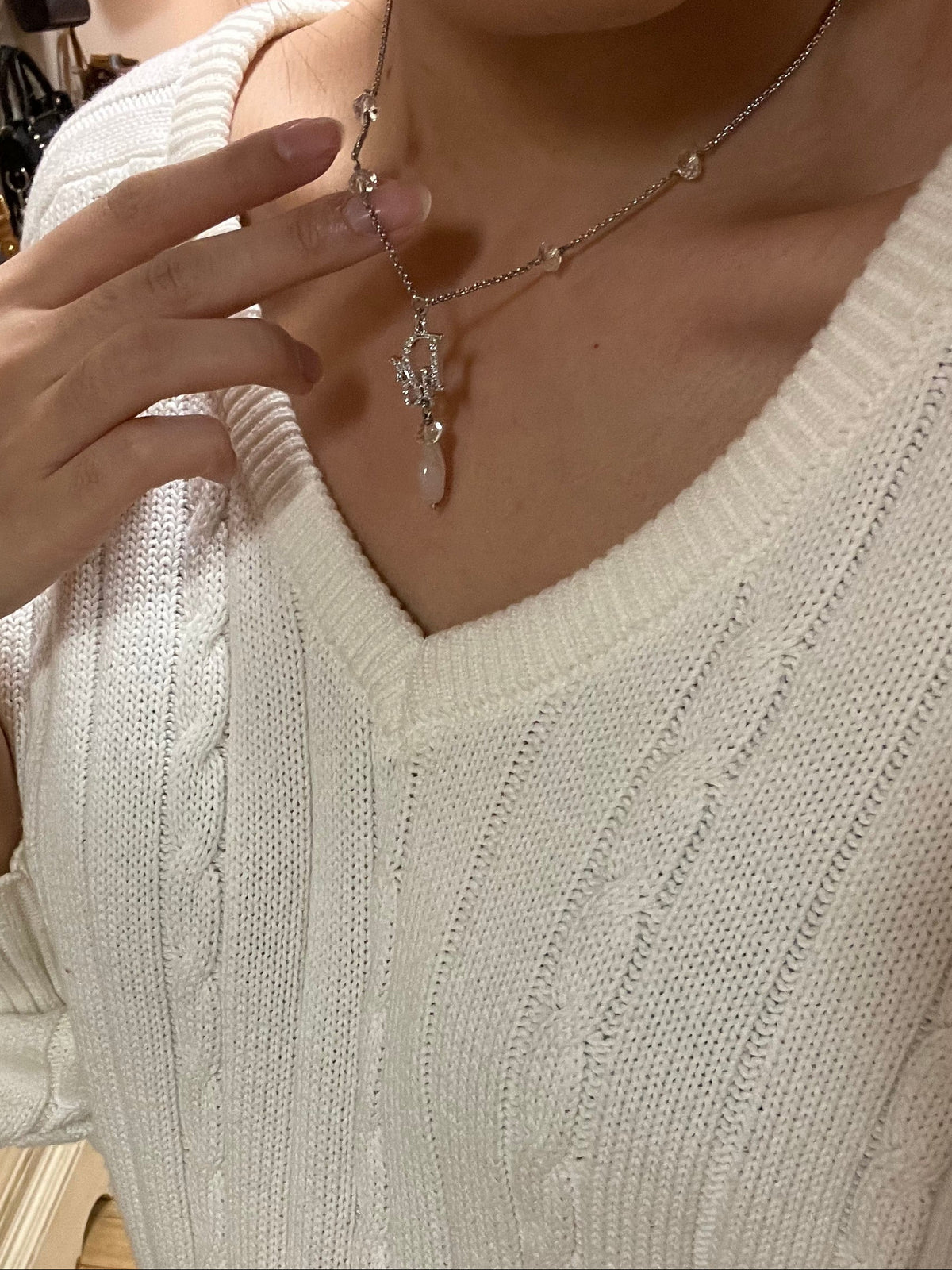 Dior silver necklace with rhinestone logo and pink teardrop stone