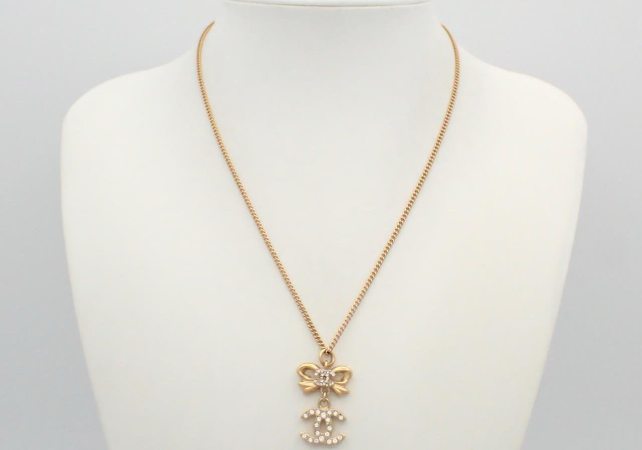 Chanel 2006 Plated Gold Crystal CC Bow Pendant Necklace
