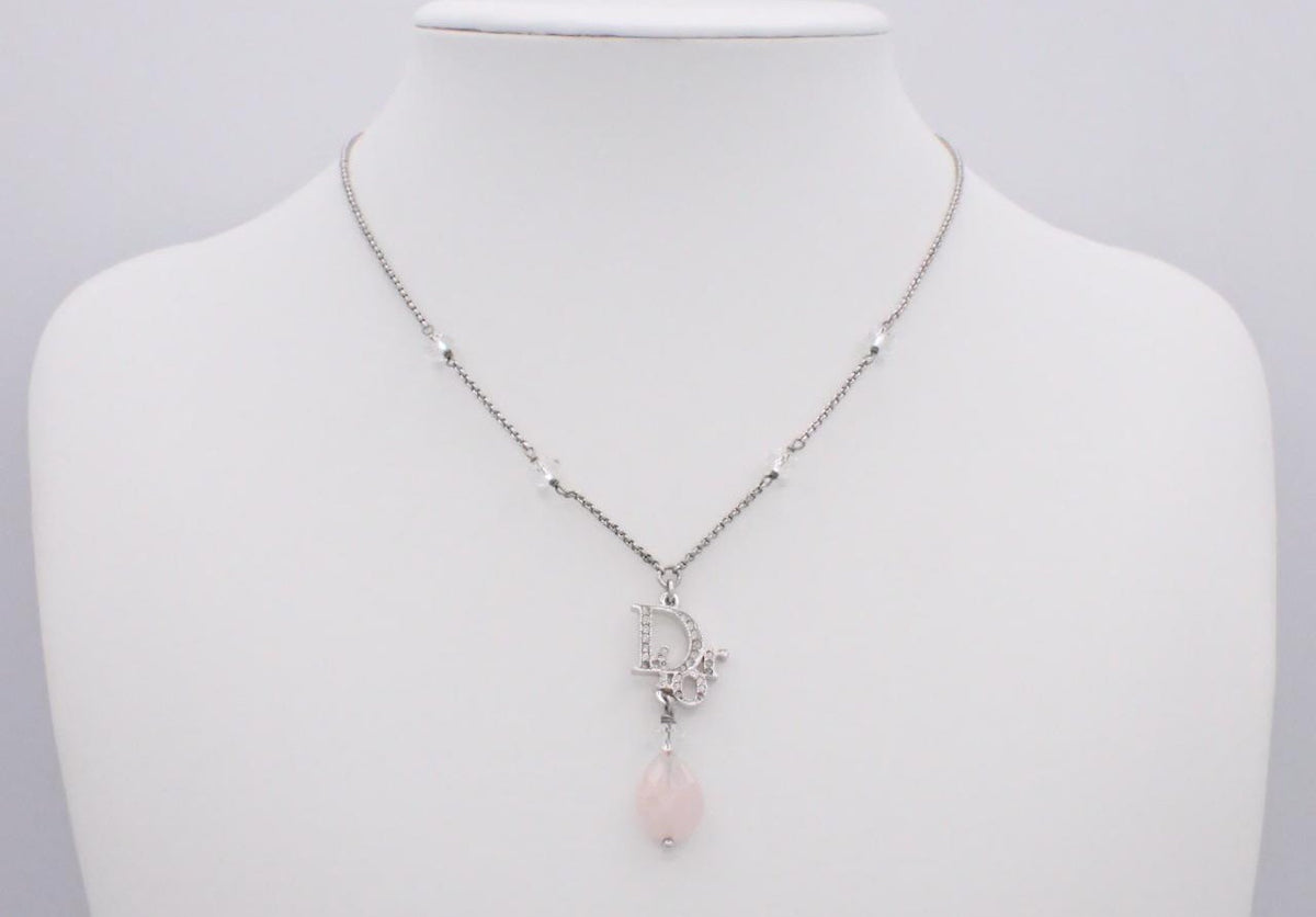 Dior silver necklace with rhinestone logo and pink teardrop stone