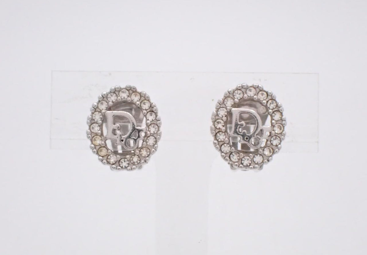 Dior silver oval clip earrings with rhinestone frame and logo