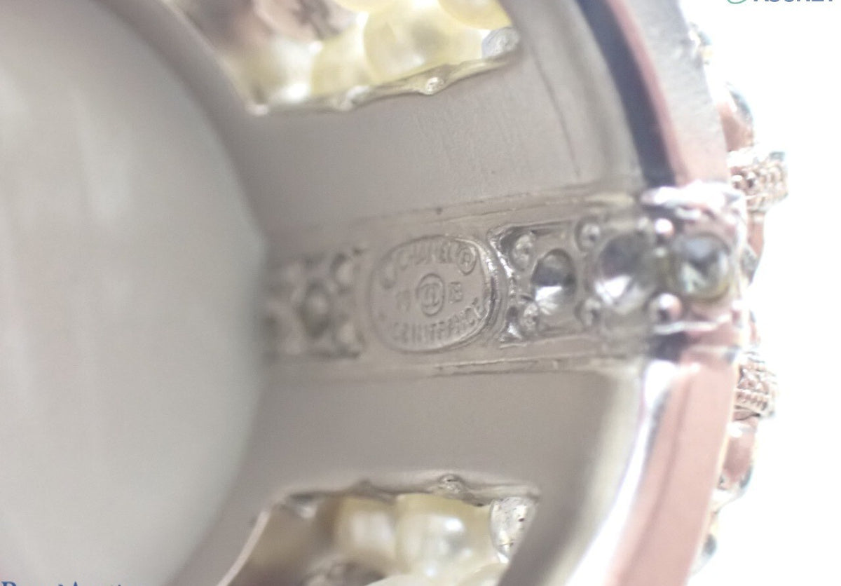 Chanel silver-tone wide band ring with crystal CC logo and white faux pearls