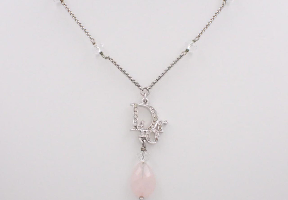 Dior silver necklace with rhinestone logo and pink teardrop stone