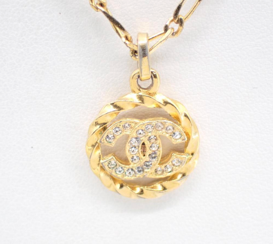 1982 Vintage Chanel Gold-tone chain with round CC medallion pendant featuring crystal accents