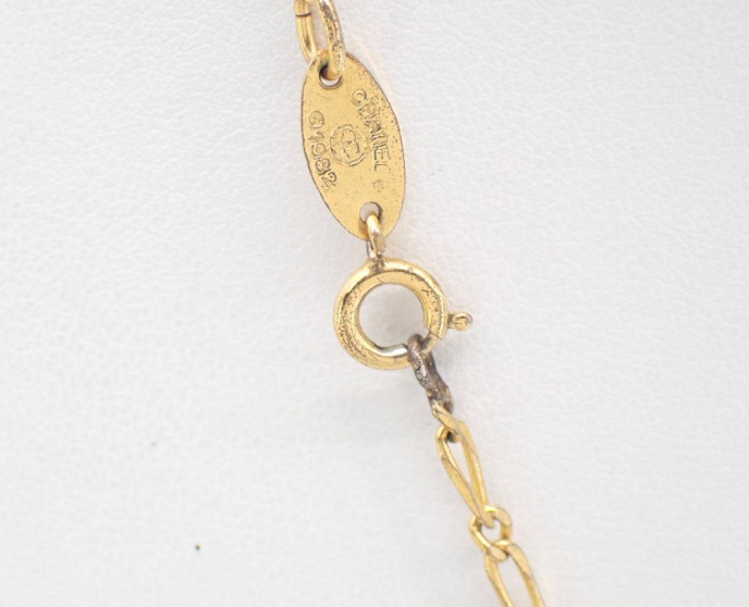 1982 Vintage Chanel Gold-tone chain with round CC medallion pendant featuring crystal accents