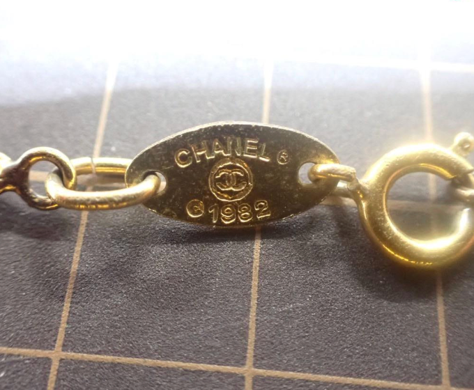 1982 Vintage Chanel Gold-tone chain with round CC medallion pendant featuring crystal accents